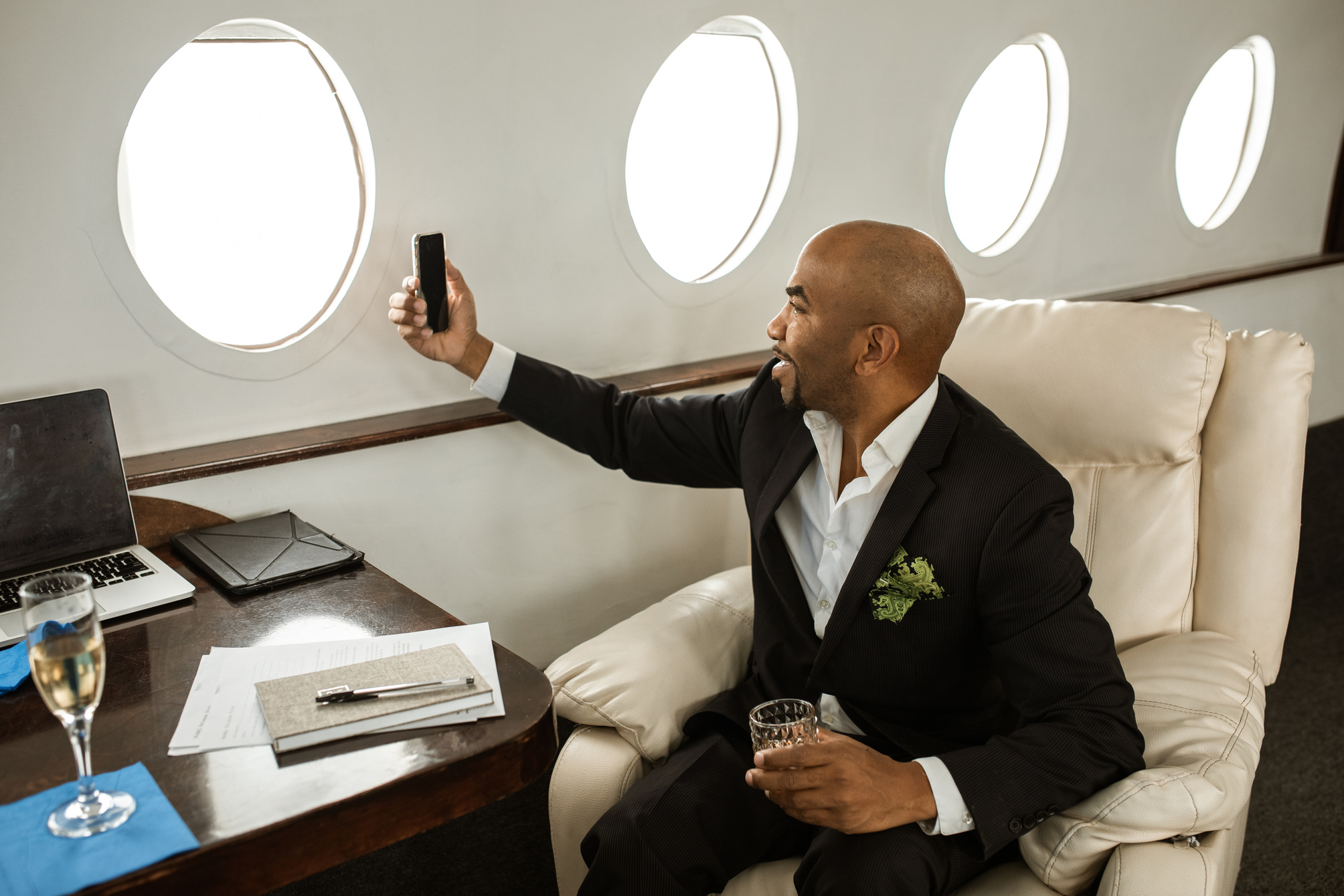 VIP Person riding a Private Jet using a Mobile Phone 